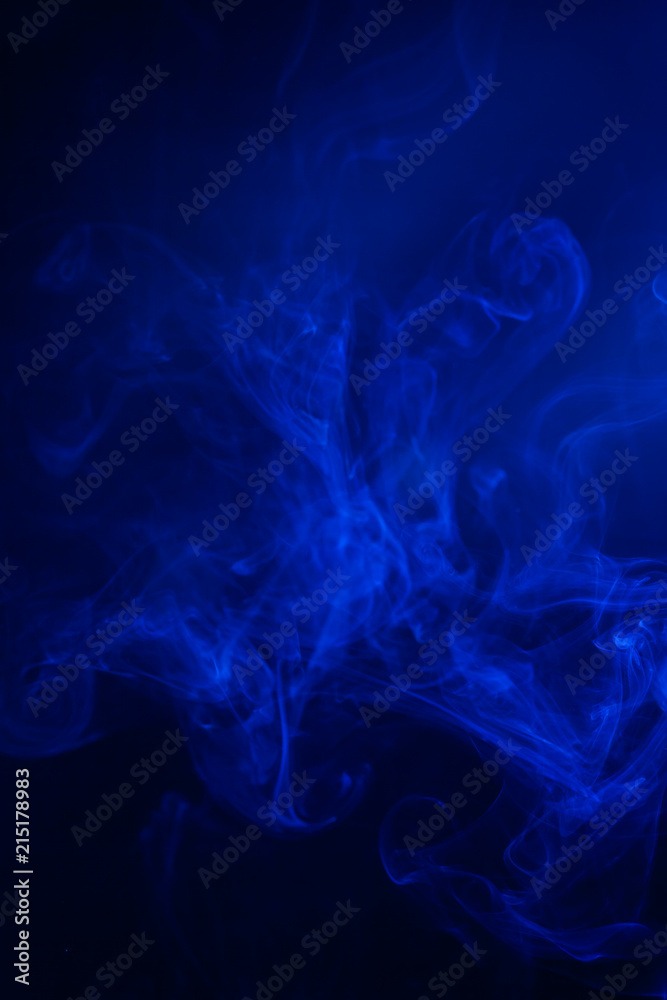 Fototapeta premium Blue smoke on black background.