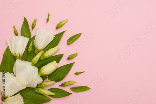 Fototapeta Naklejka Na Ścianę i Meble -  Corner composition of white eustoma flowers on pink background