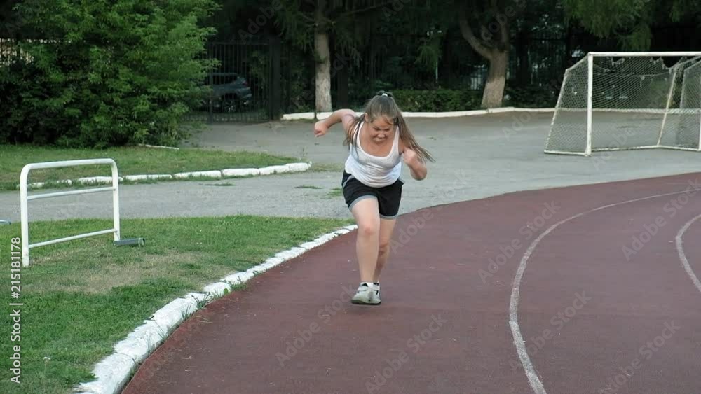 Little fat girl runs in the stadium Little fat girl runs in the stadium
