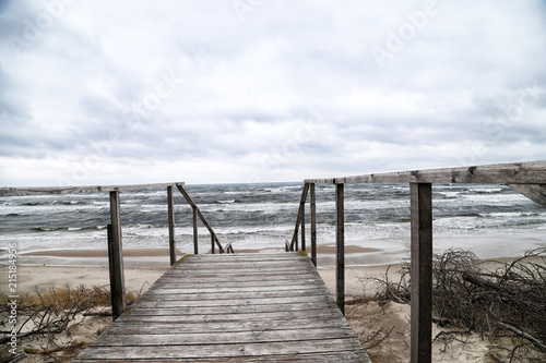 Wooden staircase among the sand on a cloudy day
