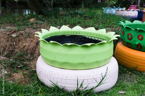 Colored green planters made from recycled tires. photo