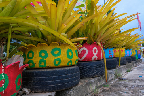 Colored green planters made from recycled tires.