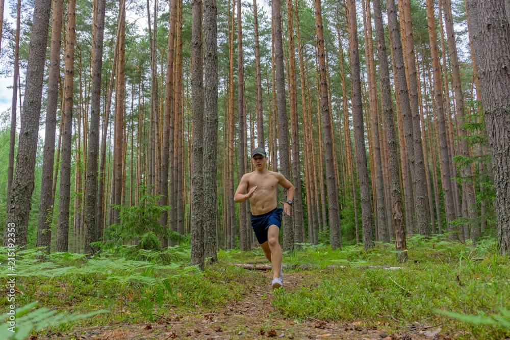 A young man is running along a flattering path A young man is running along a flattering path