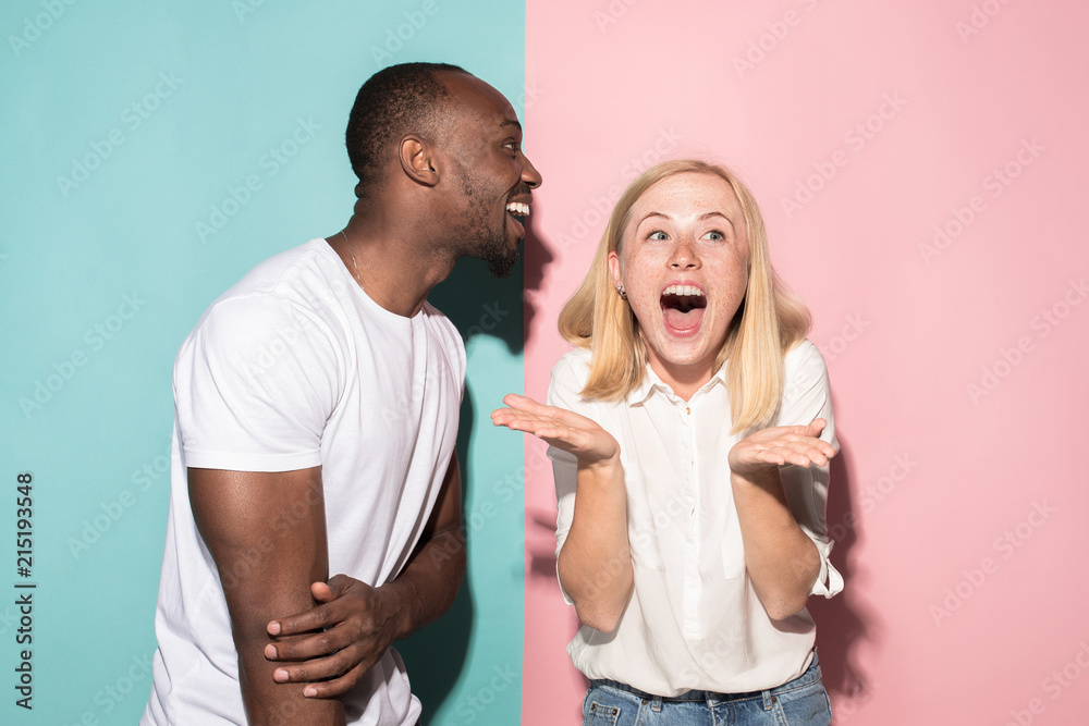 happy afro man and woman. Dynamic image of caucasian female and afro male model on pink studio. happy afro man and woman. Dynamic image of caucasian female and afro male model on pink studio.