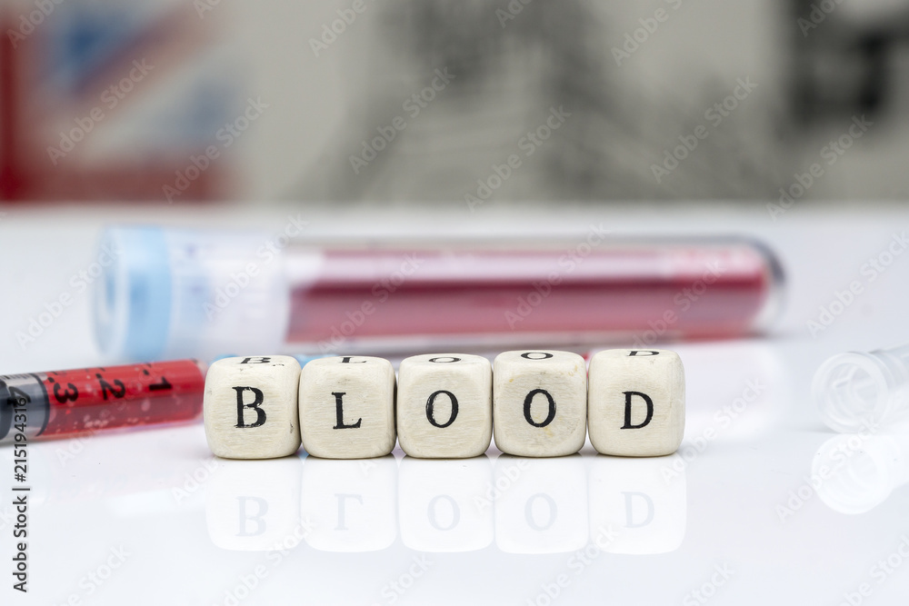 Obraz premium the 'BLOOD' concept of blood samples in the test tube, the droplets of the injection tip end