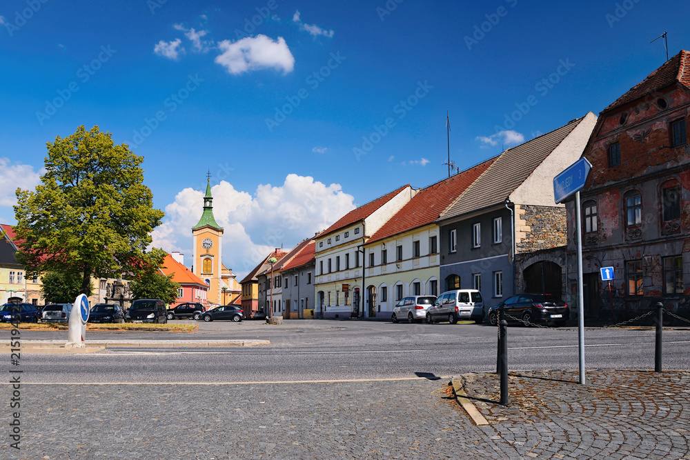 Kravare, Machuv kraj, Czech republic - July 14, 2018: intersection near the square with parked cars, historical houses and church in summer
