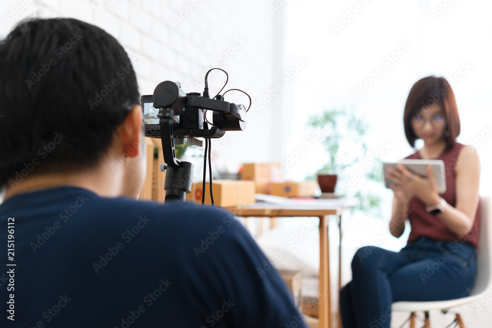 Man use compact camera recording lifestyle scene of woman use tablet with gimbal