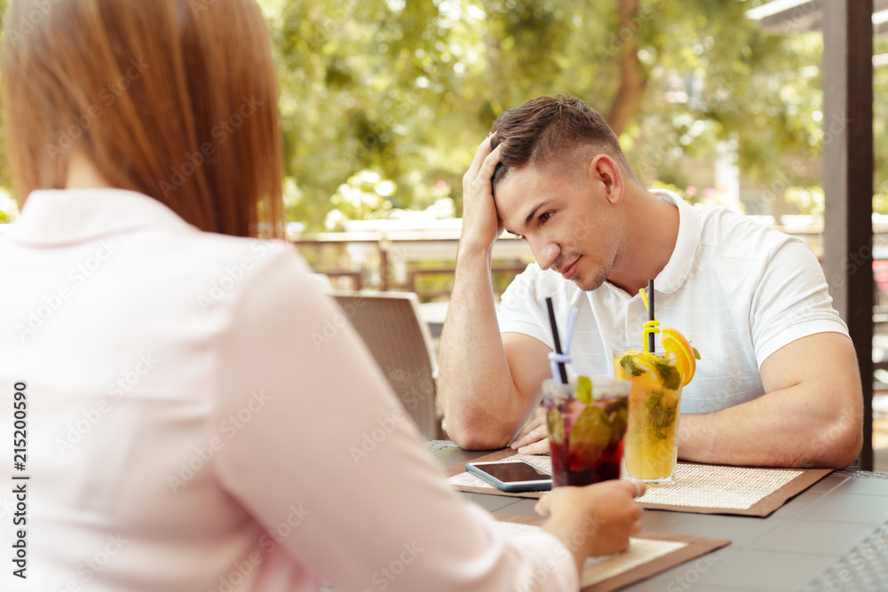 Couple having relationship problems, talking in a cafe Couple having relationship problems, talking in a cafe