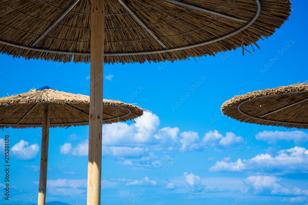 Wooden beach umbrella / Enjoying summer vacation. Copy space