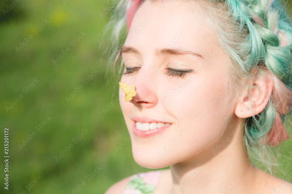 Yellow butterfly sitting on the nose Cute young girl on nature. Harmony and enjoyment in nature Yellow butterfly sitting on the nose Cute young girl on nature. Harmony and enjoyment in nature