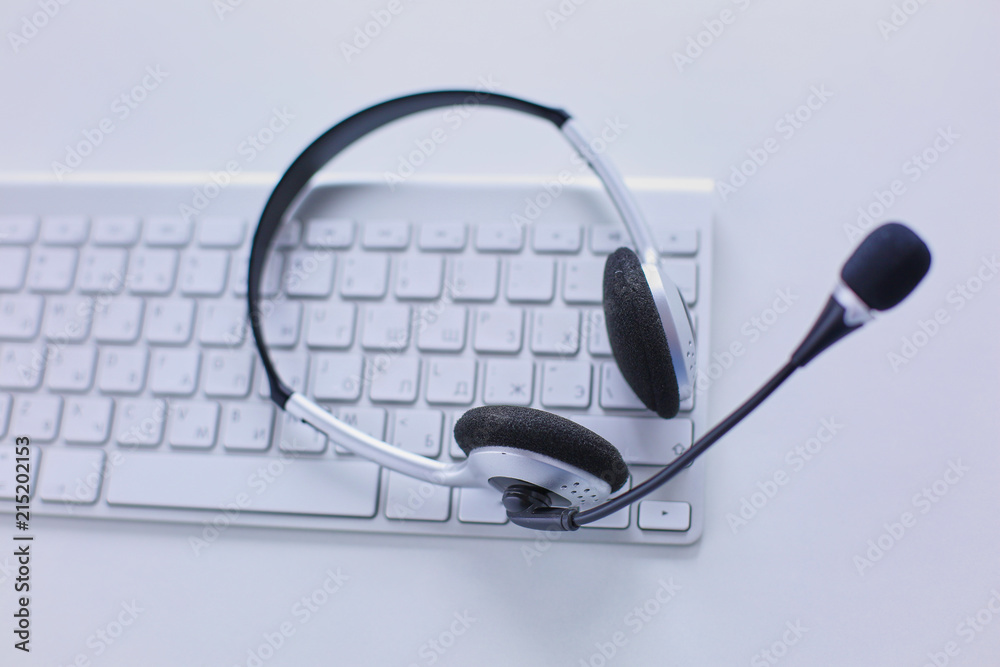 Call center and customer service help desk. VOIP headset on laptop computer keyboard Call center and customer service help desk. VOIP headset on laptop computer keyboard