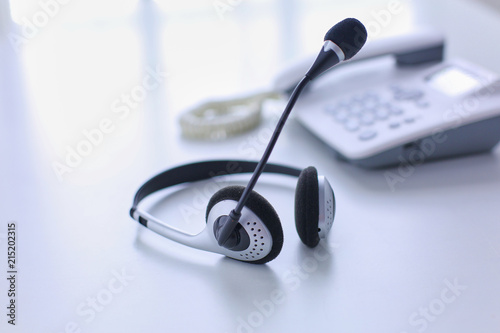 Call center and customer service help desk. VOIP headset on laptop computer keyboard