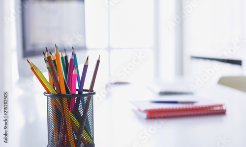 Office table with blank notepad and laptop