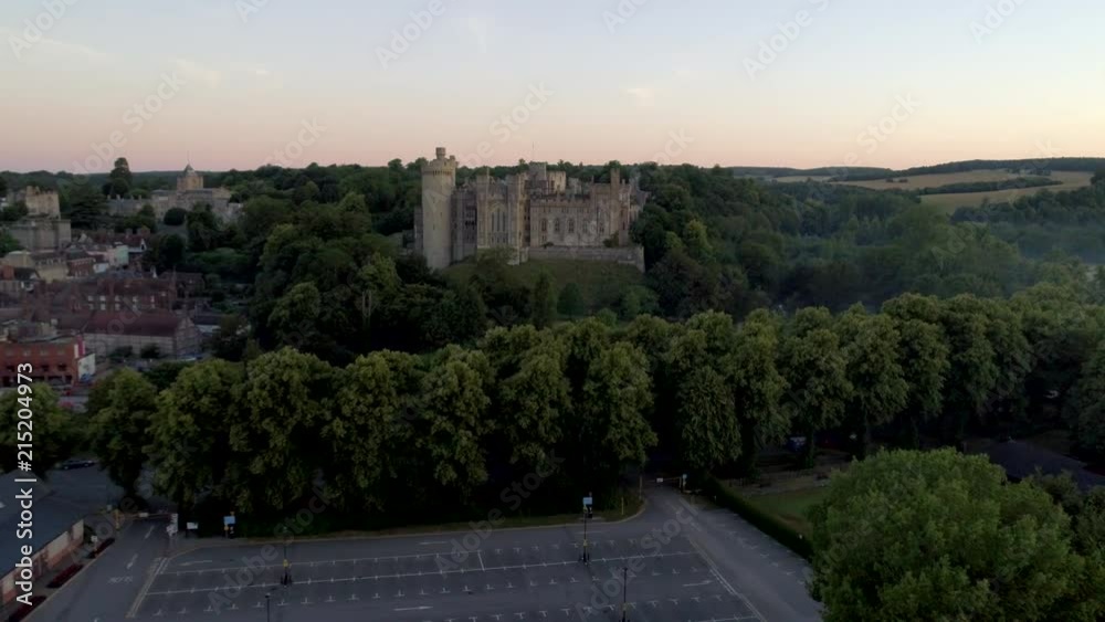 Drone flies very slowly towards Arundel Castle at sunrise