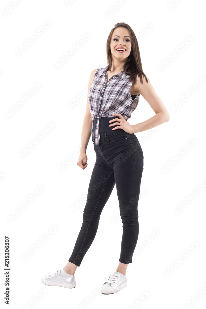 Beautiful young excited happy trendy girl with hand on hip looking away. Full body isolated on white background. Beautiful young excited happy trendy girl with hand on hip looking away. Full body isolated on white background.
