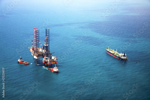 Oil rig in the gulf with oil tanker ship