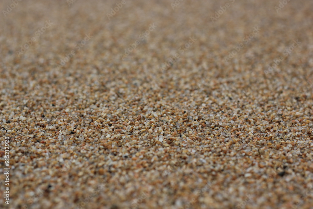 Closeup brown sandy beach background. Blurred lake Baikal gravel for textures, travel banner design Closeup brown sandy beach background. Blurred lake Baikal gravel for textures, travel banner design