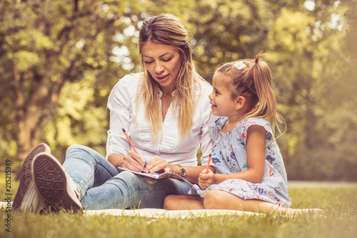 Mother and daughter at nature. Time for education.