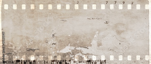 Vintage film strip frame with damaged and scratched wall surface. Sepia tones. Monochrome.