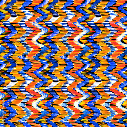 Watercolor orange and blue ikat vibrant seamless pattern. Trendy tribal pattern in watercolour style. Peacock feather for fabric, textile, ceramic