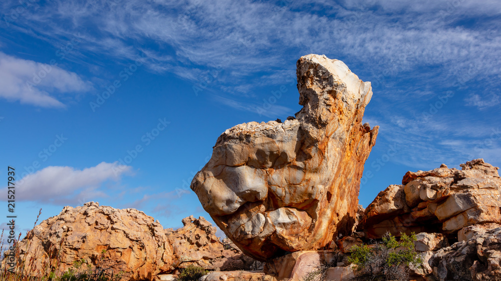 A dramatic rock formation etched against a blue sky in the Kagga Kamma Nature Reserve in South Africa