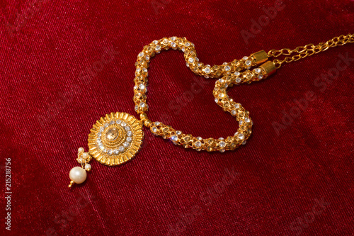 Artificial necklace on red background