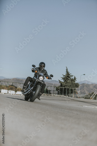Motorbike turning in a road with blue sky background. © daviles