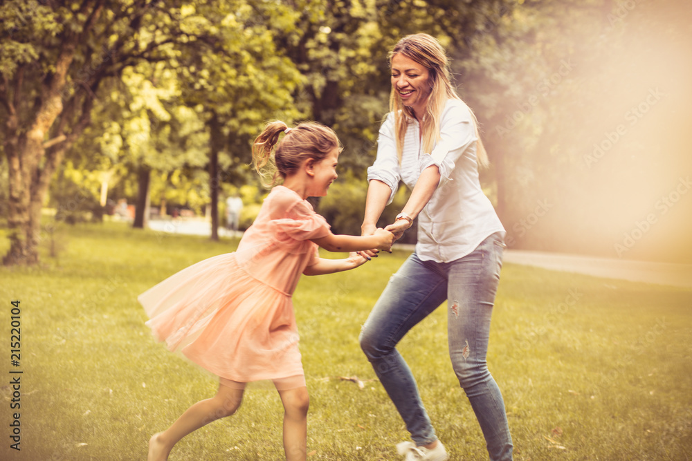 Fototapeta premium Spring season is for playing outside. Mother and daughter.