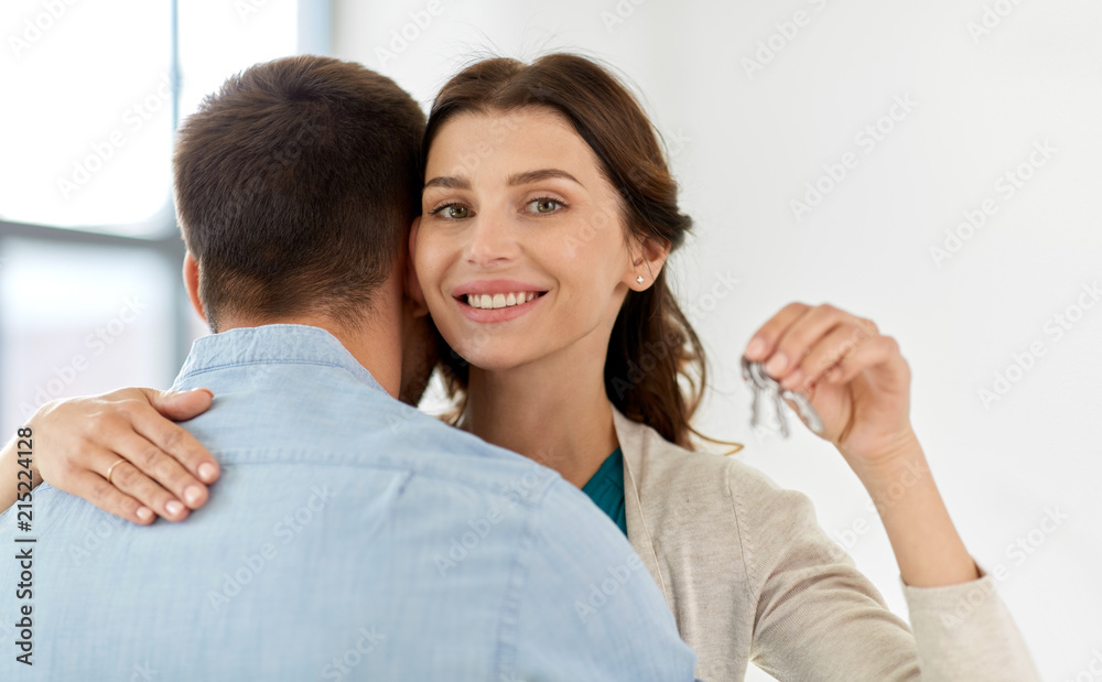 mortgage, people and real estate concept - happy couple with keys at empty room of new home mortgage, people and real estate concept - happy couple with keys at empty room of new home