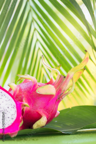 Fresh, tasty tropic, exotic dragon pitahya dragon fruit near palms photo