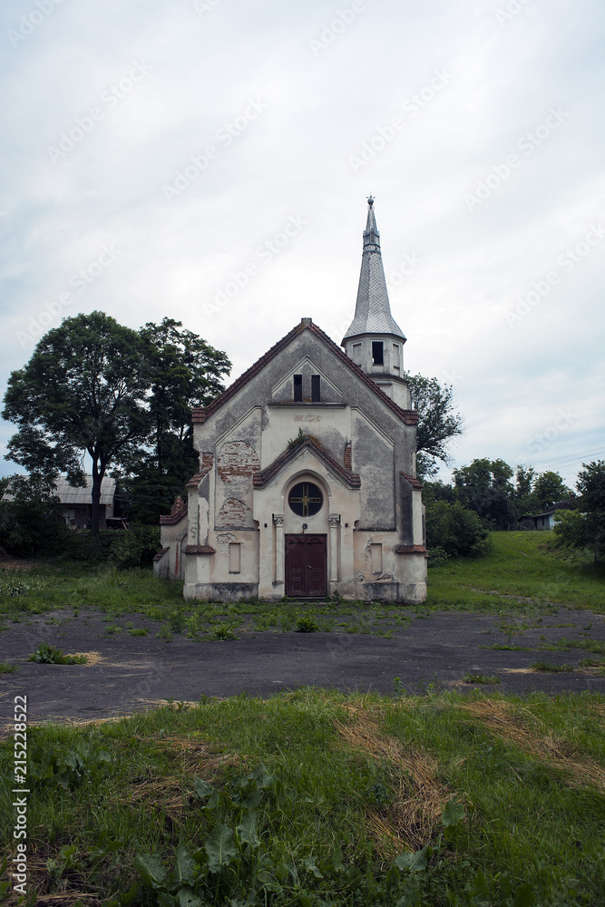Old abandoned church against dramatic dark sky