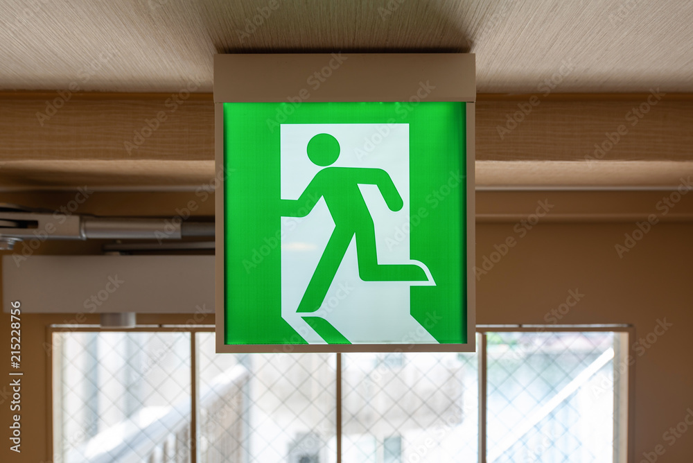 Green emergency exit sign in modern hotel. Green emergency exit sign in modern hotel.