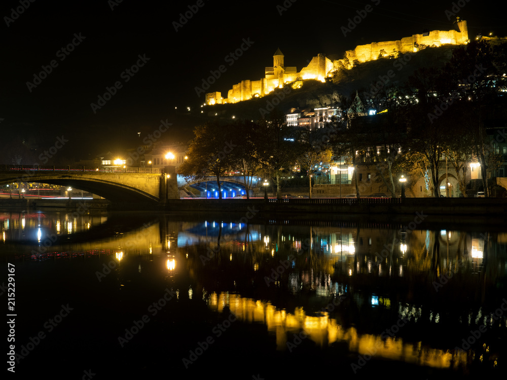 Nariakala fortress reflected in Kura river by night, Tbilisi, Georgia