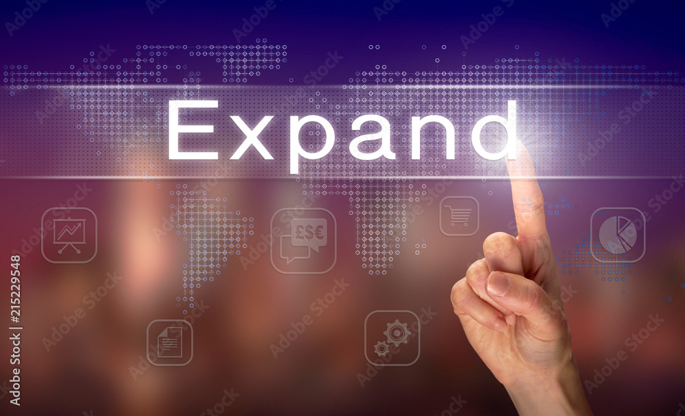 A hand selecting a Expand business concept on a clear screen with a colorful blurred background. A hand selecting a Expand business concept on a clear screen with a colorful blurred background.