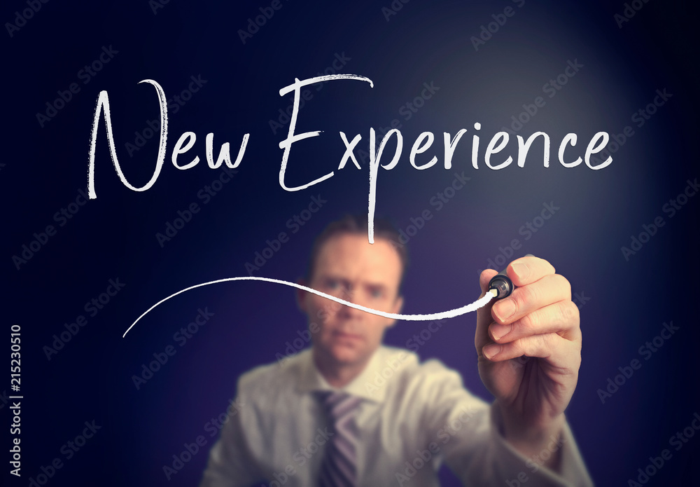 A businessman writing a new experience concept with a white pen on a clear screen. A businessman writing a new experience concept with a white pen on a clear screen.