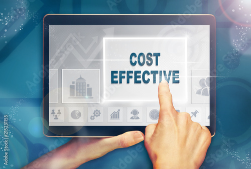 Φωτογραφία A hand selecting a cost effective business concept on a computer tablet screen with a colorful background