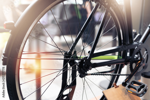 black wheel bicycle closeup on vintage scene