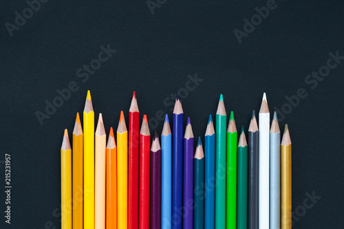 back to school Concept. Close up shot of color pencil pile pencil nibs on black background with copy space