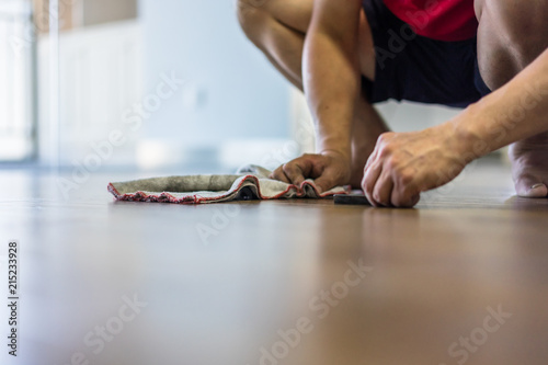 man washing floor in home