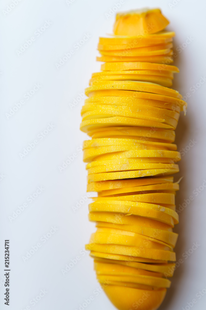 Top view of sliced summer yellow squash on white background Top view of sliced summer yellow squash on white background