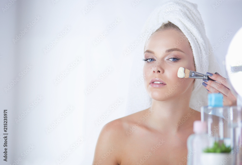 Young beautiful woman making make-up near mirror, in bathroom Young beautiful woman making make-up near mirror, in bathroom