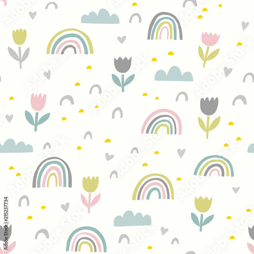 Cute vector pattern with flowers, rainbows and clouds. Spring abstract hand drawn whimsical seamless background in pastel colors.