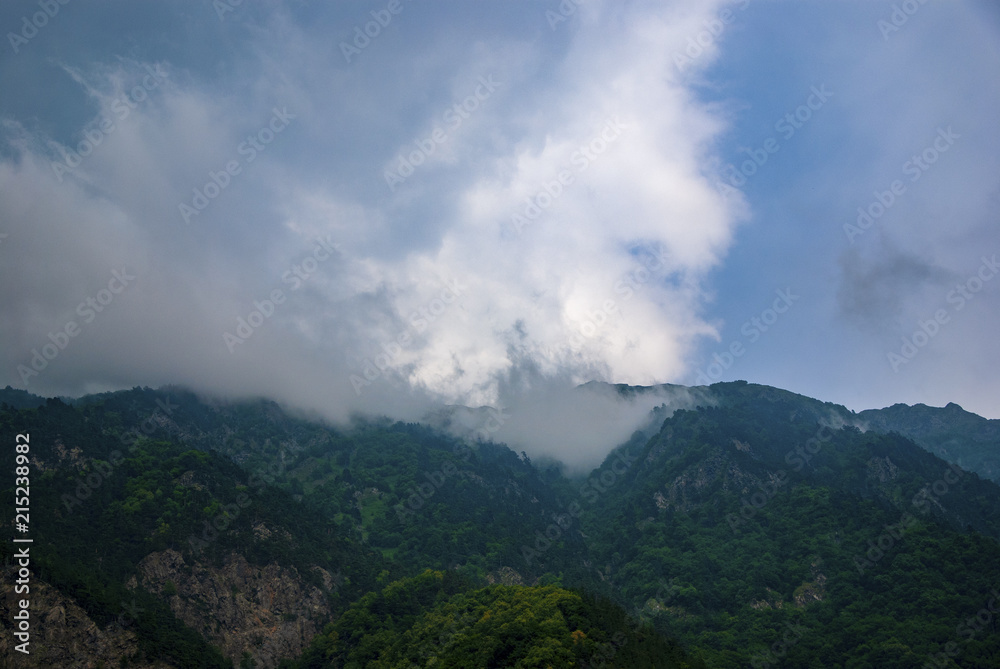 A beautiful mountain landscape, overlooking the height with clouds