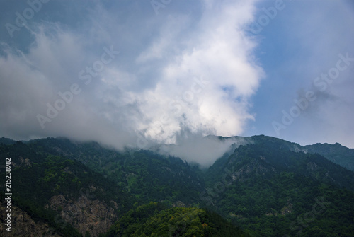 A beautiful mountain landscape, overlooking the height with clouds © Alexandr