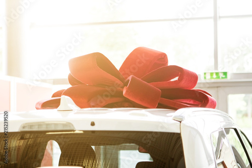 New car with red bow as present concept