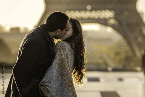 Couple kissing each other at Eiffel Tower photo