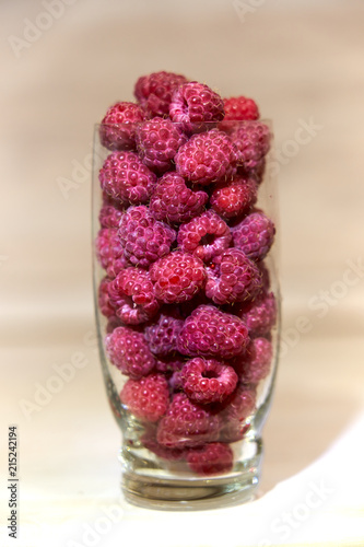juicy fresh raspberries in a glass