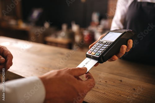 Customer doing payment credit card in cafe photo