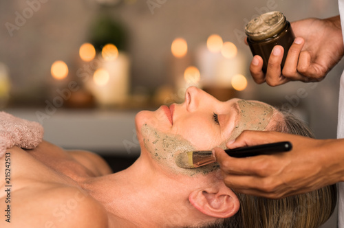 Woman with clay mask on face