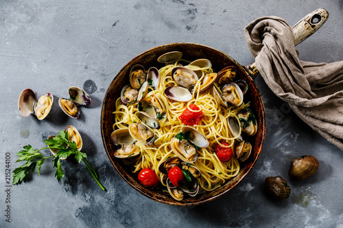 Pasta Spaghetti alle Vongole Seafood pasta with Clams in frying cooking pan on concrete background
